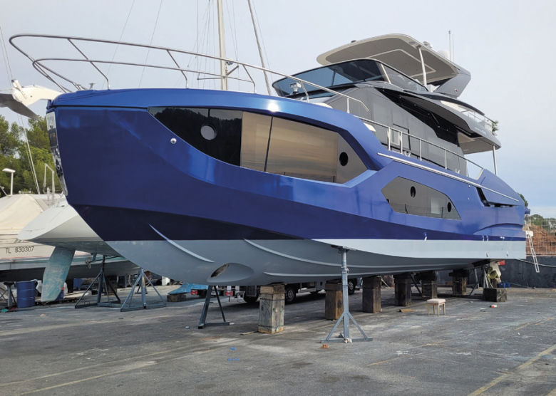 Absolute 60 Fly M/Y Strong Spirit featuring custom midnight blue hull wrap and metallic black vinyl superstructure